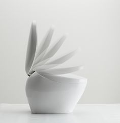 a white vase sitting on top of a table