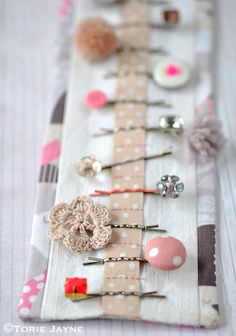 there are many pins and needles on this fabric strip that is decorated with polka dots