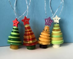 three small wooden christmas trees with star decorations