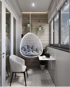 a white hanging chair next to a window