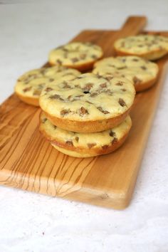 several cookies sitting on top of a wooden cutting board