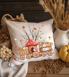 a decorative pillow with an image of a train carrying pumpkins and mushrooms on it