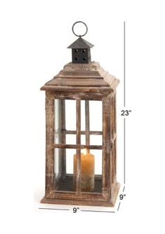 an old wooden lantern with a candle in it's glass case on a white background