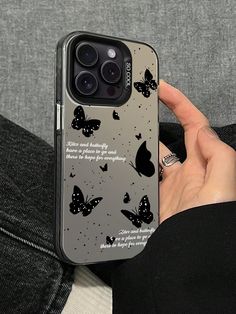 someone is holding up their phone case with butterflies on it