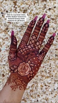 the hand is decorated with henna and flowers