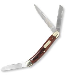 a knife that is on top of a white surface with a brown handle and gold trim