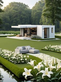 a modern house with white flowers in the foreground and green grass on the ground