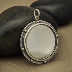 Mirror Pendant - Sterling Silver Mirror Frame, Framed Pendant, Art Deco Pendant, Reflection Charm, Art. Artist Pendant, Sterling Mirror. This sterling silver mirror pendant with granulation features a real mirror at the center of the design, and silver dots along the edge of the darkened, oxidized frame. The overall effect is moody, dramatic, and stormy. Spiritually, mirrors are closely associated with light, illumination, spiritual awareness and wisdom. Many believe mirrors reflect truth by ini Mirror Necklace, Mirror Pendant, Art Nouveau Pendant, Art Deco Pendant, Monogram Jewelry, Self Reflection, Bad Luck, Silver Mirror, Celestial Jewelry