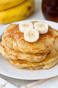 a stack of pancakes with bananas on top