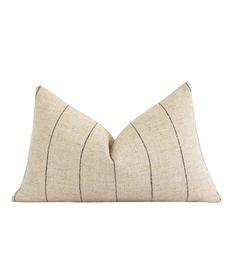 a beige and black striped pillow on a white background with the back side of it