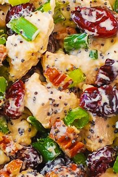 a salad with chicken, broccoli and raisins in it is ready to be eaten