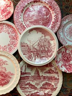 a pile of red and white plates sitting on top of a rug