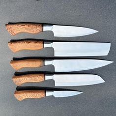 four knives are lined up in a row