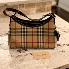 **Updated With Serial Number** Burberry Nova Check Small Zippered Handbag With Shoulder Strap. Small Press Snap Closure Buckle On Side. One Small Interior Pocket And One Larger Zippered Interior Pocket. 9.5"X4.5"X7.5". Brown Leather Trim (Appears Darker In Photo). Great Condition. Burberry Care Card Included. Original Certificate Of Authenticity And Care Bag Not Included. Burberry Purse, Mini Pouches, Care Card, Selling On Poshmark, 2025 Vision, Burberry Bag, Certificate Of Authenticity, Luxury Items, Leather Trim