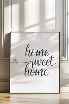 a sign that says home sweet home on the floor in front of a white wall