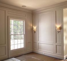 an empty room with white walls and doors