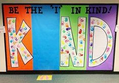 colorful bulletin board with handprints and the words be the it in kind on it