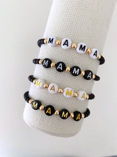 one mama name bracelet made with 4mm black matte beads with 14k gold spacer beads letters will be evenly spaced bracelets are made on a durable stretch elastic cord please refer to our sizing guide before purchasing Alphabet Beads Keychain, Name Beaded Bracelet, Alphabet Bracelet Ideas, Funny Bracelets Beads Words, Letter Bracelet Beads Ideas, Bead Bracelet Words Ideas, Letter Bracelet Beads, Alphabet Bracelets, Beads Letters