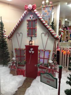 a gingerbread house decorated with candy canes and candies