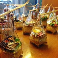 several bags filled with food sitting on top of a wooden table