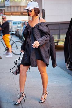 a woman walking down the street in heels