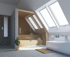 an attic bathroom with skylights and a bathtub