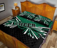 a bed with a green and black comforter on it