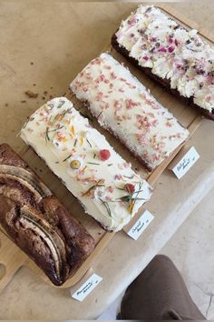 four different types of bread on display in a bakery