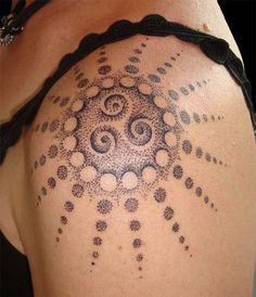 the back of a woman's shoulder with dots and circles on her body,