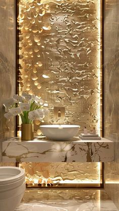 a bathroom with a sink, toilet and gold foiled wall