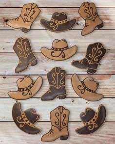 cowboy hats and boots decorated cookies on a wooden table