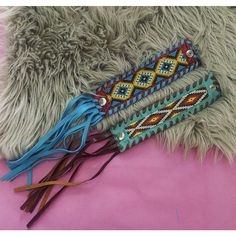 three colorful beaded bracelets laying on top of a fur covered floor next to each other