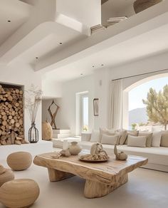 a living room filled with furniture and a firewood log table in front of a large window