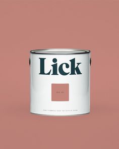 a pink paint can with the word lick painted on it's side, in front of a purple background