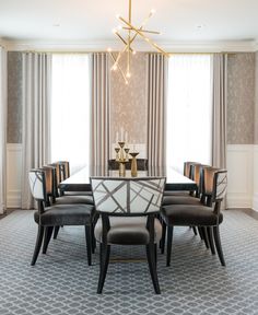 a dining room table with six chairs and a chandelier