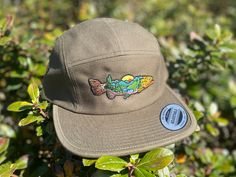 Embark on your next angling adventure with our exclusive fly fishing-themed camp hat, crafted for outdoor enthusiasts who crave the serenity of the water and the thrill of reeling in the perfect catch. Our hat features a captivating logo of a majestic trout set against a vibrant sunrise backdrop, symbolizing the beauty and tranquility of the early morning fishing experience. Inspired by the untamed beauty of nature and the adrenaline rush of fly fishing, our brand is dedicated to providing high-quality gear for outdoor enthusiasts like you. Whether you're casting your line in a remote mountain stream or drifting along a tranquil river, our products are designed to enhance your fishing experience and help you connect with the great outdoors. Join the ranks of outdoor aficionados who share y Nature, Fishing Outfit, Camp Hat, Adventure Hat, Adventure Accessories, Outdoor Adventure Gear, Fishing Apparel, Modest Clothes, Adventure Outfit