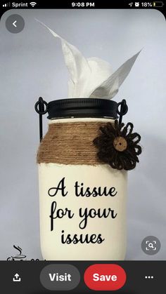 a mason jar with a flower on it and a tissue paper dispenser