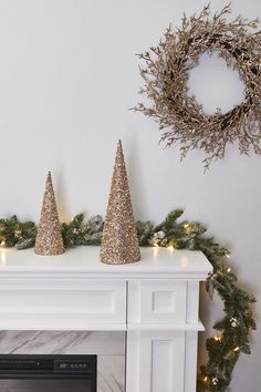 three christmas trees sitting on top of a mantle