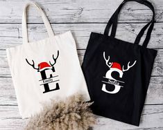 two christmas bags with reindeer heads on them, one is black and the other is white