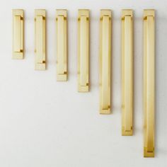 five wooden handles are lined up on a white surface