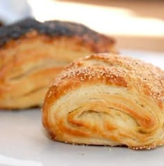 two croissants sitting on top of a white plate