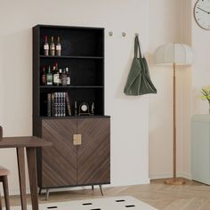 a room with a table, chair and bookcase in it next to a clock on the wall