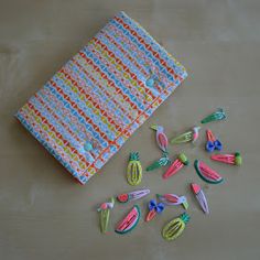 several small plastic objects are laid out on a table next to a cloth and scissors