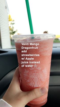 a person holding up a drink in their hand that says, venti mango dragonfruit add strawberries apple instead of watermelon