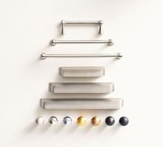 an assortment of door handles and knobs on a white wall with five different colors