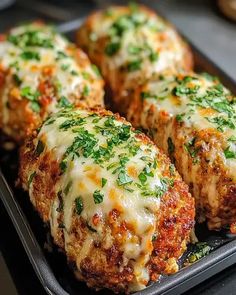 four meatballs covered in cheese and parsley