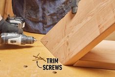 a person using a drill to attach screws on a piece of wood with the words trim screws below