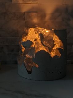 a fire pit with ice on the bottom and flames coming out of it's sides