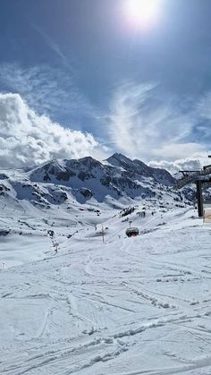 the sun shines brightly on snow covered mountains