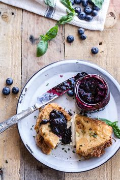 a white plate topped with blueberries and bread